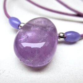 Huge chunky amethyst necklace, a 30-20 mm tumbled amethyst sided with 2 smaller amethyst beads and silvery decorative elements, purple leather cord 55 cm