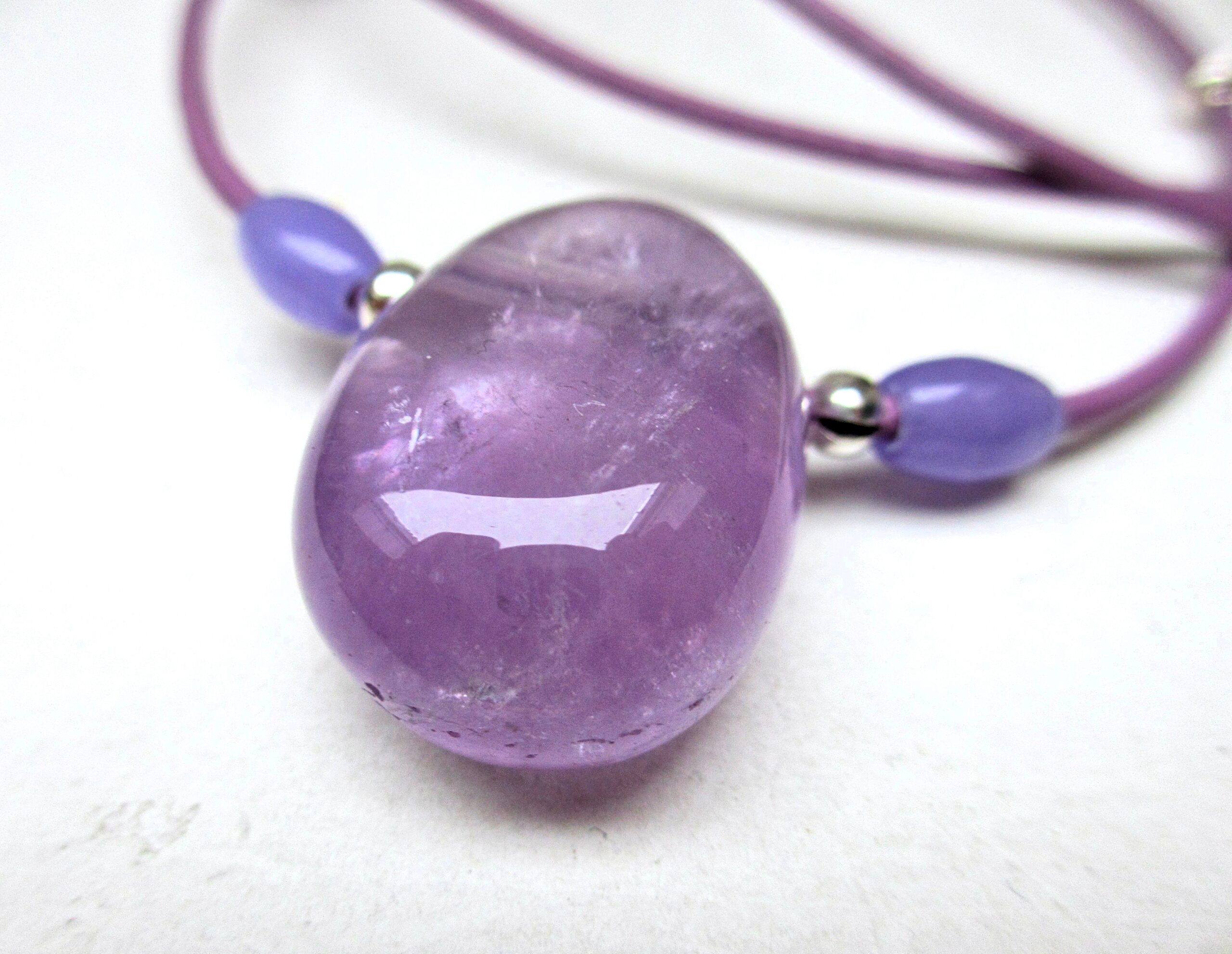 Huge chunky amethyst necklace, a 30-20 mm tumbled amethyst sided with 2 smaller amethyst beads and silvery decorative elements, purple leather cord 55 cm